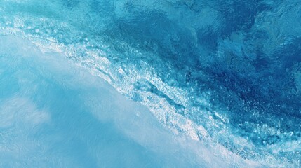 Soft waves create a serene atmosphere as they wash onto a sandy beach. The clear blue water sparkles in the sunlight, inviting relaxation and peace.