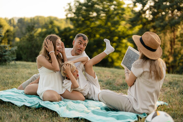 A happy family celebrates together during an outdoor gender reveal announcement.
