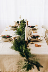 Elegant dining table decoration with greenery and candles for a festive gathering