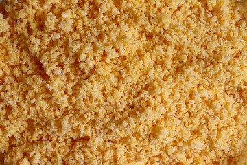 Flaked, pre-cooked flour for brazilian couscous. Moistened couscous mixture. Cuscuz brasileiro.
 