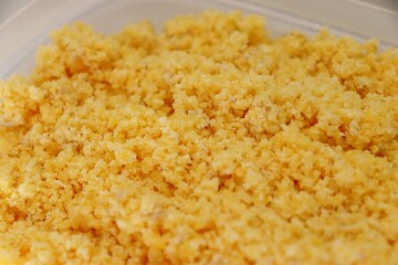 Flaked, pre-cooked flour for brazilian couscous. Moistened couscous mixture. Cuscuz brasileiro.
 