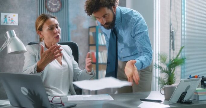 Frustrated business manager argues with female assistant, tossing papers during a tense office dispute. Workplace conflict and stress. Part 29 of the &ldquo;Dad&rsquo;s Day&rdquo; series.