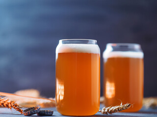 Two glasses of wheat beer on the table. Wheat ears, stylish glasses