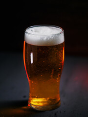 Light cold beer in water drops on the table