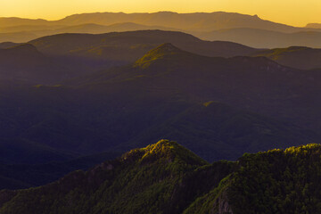 Sunset over Sutjeska National Park, viewed from Prijevor, Bosnia and Herzegovina. Mountain layers and golden light create a peaceful, scenic landscape in untouched nature.