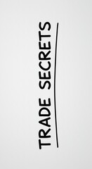 Trade Secrets - Hand-Written Text on a Whiteboard in Black and White.
