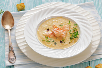 creamy salmon soup with herb in a bowl