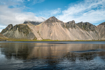 Scenic View of Vestrahorn Mountain Reflecting in Calm Icelandic Waters