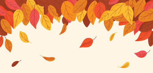 Obraz premium Falling autumn leaves in warm colors creating a beautiful seasonal background