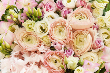 Summer blossoming delicate ranunculus on blooming flowers festive background, pastel and soft bouquet floral card, selective focus