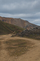 Dirt Trail Through Rocky Terrain and Rhyolite Mountains in Iceland