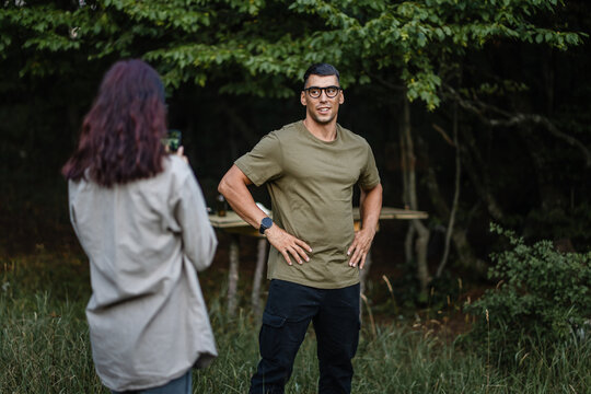 Soldier posing for photo during camping trip in forest