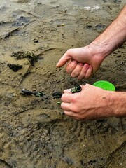 fisherman prepares bait on a feeder