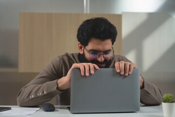 Man closing laptop computer working from home office desk with glasses and mustache looking down view shot