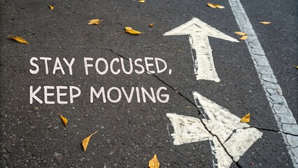 Inspirational Quote on Pavement with Leaves and Arrows Symbolizing Direction