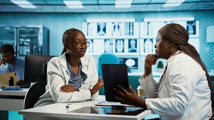 Doctor conducting a patient consultation in a professional medical office, analyzing diagnostic...