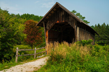 Obraz premium The Martin Covered Bridge, a landmark agricultural bridge built in 1890, spans the Winooski River just off U.S. Route 2 in southern Marshfield, Vermont.