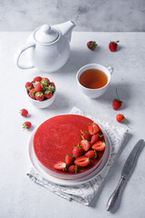 Strawberry mousse cake in a plate on a white background