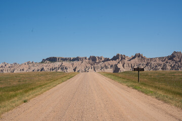 Winding road through rocky formations under clear blue sky