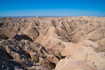 Layered rock formations under clear sky in Badlands National Park, South Dakota