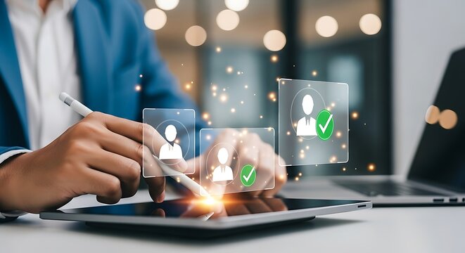 Recruitment and selection process using digital technology, a professional reviews candidate profiles on a tablet with a laptop in the background