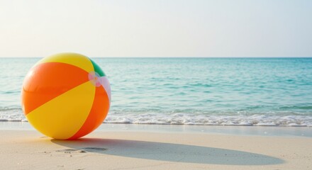 Colorful beach ball on the sand