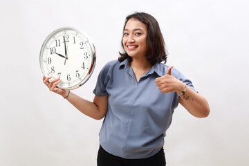 Happy Asian woman standing while showing 10 o'clock and making thumbs up