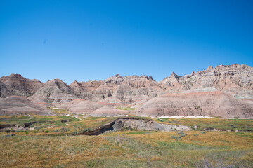 Colorful eroded hills and green vegetation in Badlands National Park, South Dakota