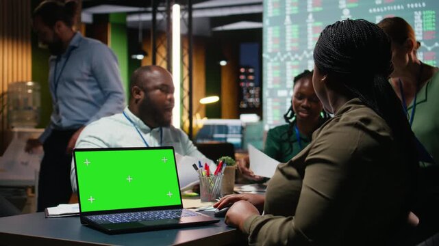 Team of office workers meeting late at night next to copy space screen, attending a late advisory board session to build a strategy and setting objectives for project agenda. Camera A.