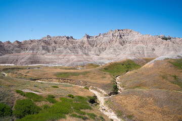 Colorful eroded hills and green vegetation in Badlands National Park, South Dakota
