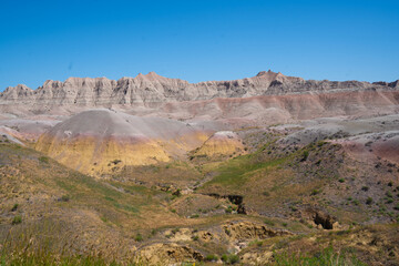 Colorful eroded hills and green vegetation in Badlands National Park, South Dakota