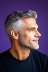Obraz premium A confident and modern man embracing his look. Modish men's undercut haircut - midlife middle eastern man with short hair. Purple solid background. Visual idea of style for aging men.