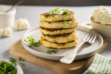 Vegetarian cauliflower pancakes, fritters served with sour cream 