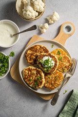 Vegetarian cauliflower pancakes, fritters served with sour cream 