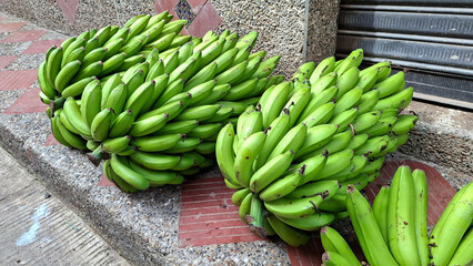 Many freshly picked green bananas - Market square in a Colombian village