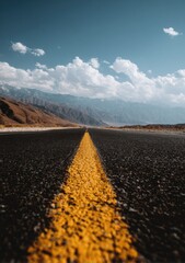 Fototapeta premium Road stretching into a mountainous landscape