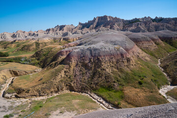 Colorful eroded hills and green vegetation in Badlands National Park, South Dakota