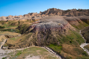 Colorful eroded hills and green vegetation in Badlands National Park, South Dakota