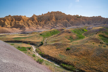 Eroded grassy hills and rock formations in Badlands National Park, South Dakota