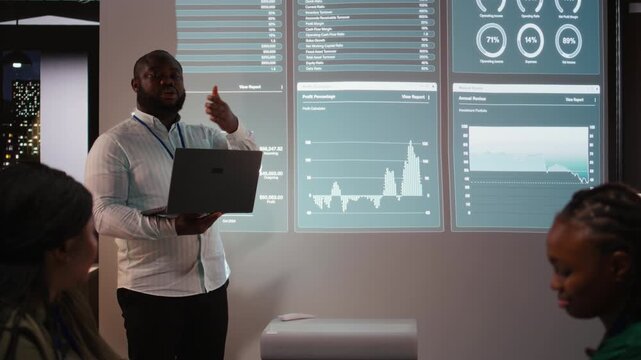 Team of firm coworkers analyzing their pitch ideas for an important meeting, working on ways to obtain more funds. Professional people address financial status at night time. Camera A.