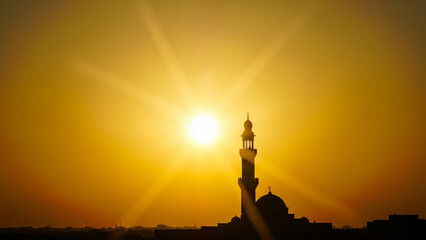 Fototapeta premium silhouette of mosque under the sunset sun