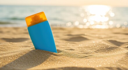 Sunscreen bottle on beach sand