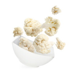 Cauliflower florets and bowl in air against white background