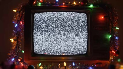 Animated scene of a glowing CRT TV with static snow, multicolored fairy lights, and 90s garland - Powered by Adobe