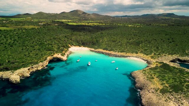 Experience the stunning turquoise waters and secluded beach of Cala Varques Mallorca, a hidden gem perfect for your next summer getaway
