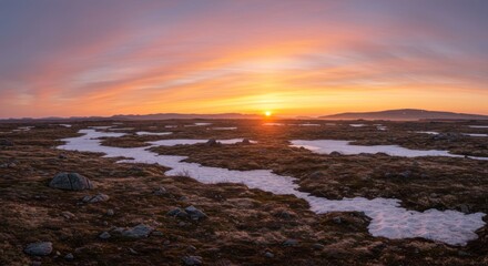 Obraz premium Sunrise over a snow-flecked moor