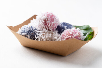 Thai coconut ball (Khanom Tom), Traditional Thai dessert made from boiled glutinous rice flour stuffed with sweet coconut and coated with shredded coconut