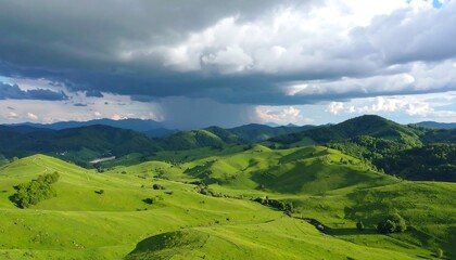 Naklejka premium Lush green hills under stormy clouds
