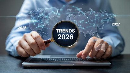 Examining future trends with magnifying glass over a global map, forecasting business growth