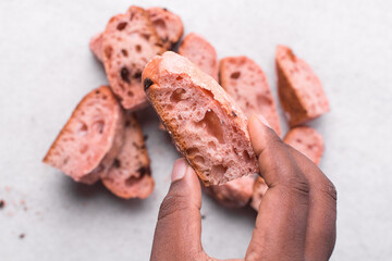 Overhead view of strawberry and chocolate sourdough, top view of pink and chocolate artisan bread on a white background, open crumb artisan bread